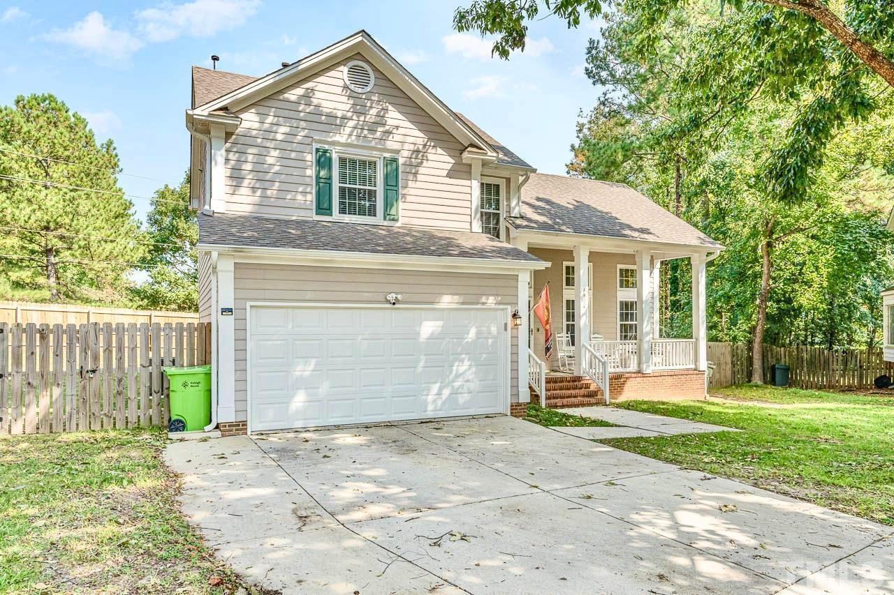 8824 Whitby Court Raleigh, NC 27615 - Photo 2 of 25 a front view of a house with a yard and garage