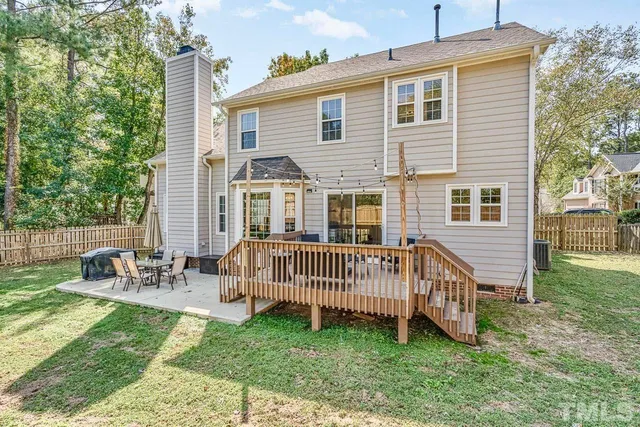 a view of a house with a yard and deck