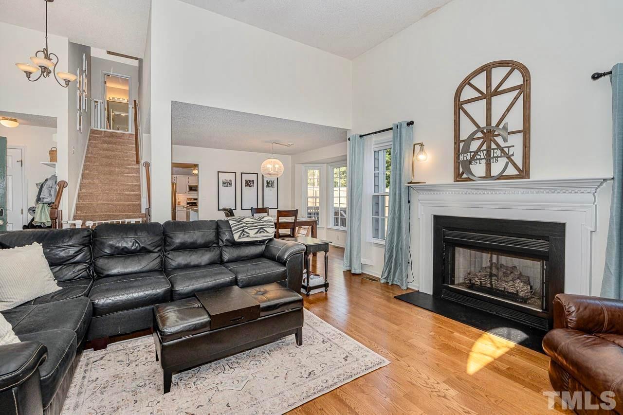 8824 Whitby Court Raleigh, NC 27615 - Photo 5 of 25 a living room with furniture and a fireplace