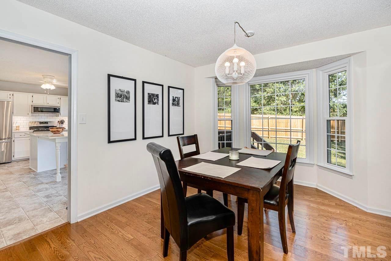 8824 Whitby Court Raleigh, NC 27615 - Photo 7 of 25 a view of a dining room with furniture window and wooden floor