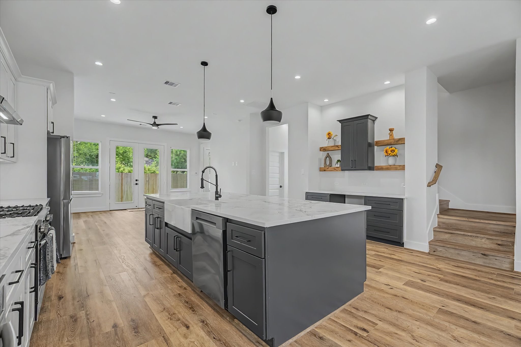 3806 Dreyfus Street Houston, TX 77021 - Photo 10 of 48 Modern kitchen featuring an apron-front sink, complemented by a high-efficiency Samsung 5.0 Cu. Ft. Smart Front Load Washer with Steam. This Wi-Fi-enabled appl