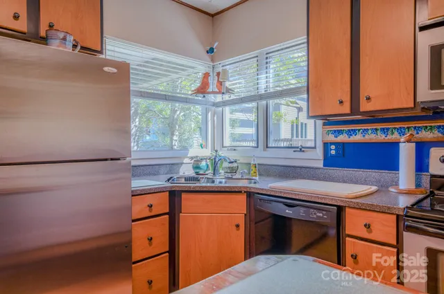 a kitchen with stainless steel appliances granite countertop a sink and cabinets