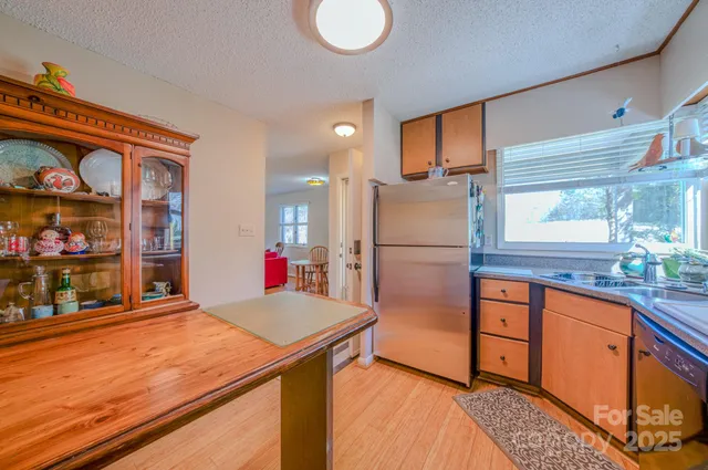 a kitchen with stainless steel appliances granite countertop a refrigerator and a sink