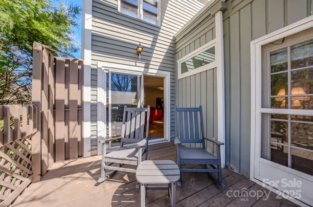 a view of a patio with a table and chairs and a barbeque