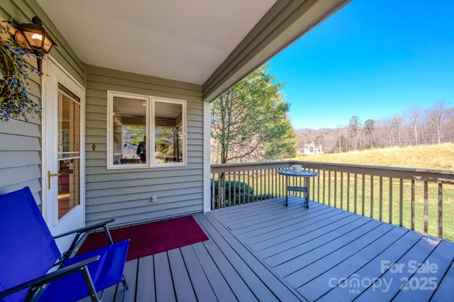 a view of balcony with wooden floor and seating space