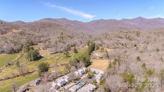 a view of mountain with sunset in background