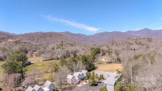 a view of houses with a street and a mountain