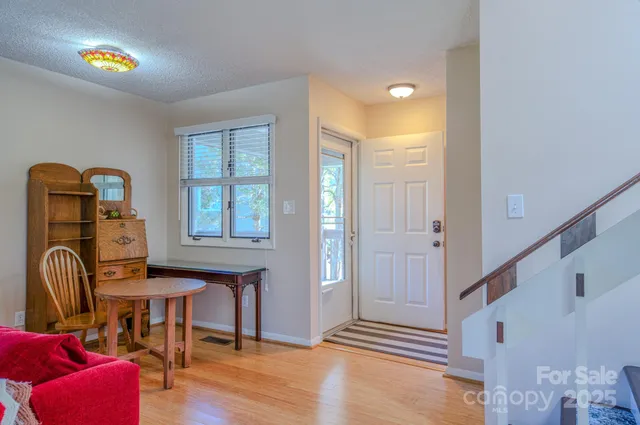 a view of a hallway with entryway wooden floor and front door