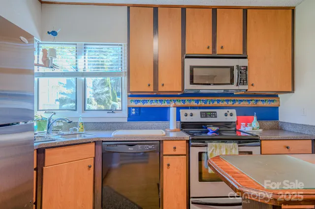 a kitchen with stainless steel appliances granite countertop a stove and a sink