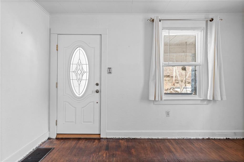 1341 Scrubgrass Road Carnegie, PA 15106 - Photo 4 of 21 an empty room with wooden floor cabinet and windows