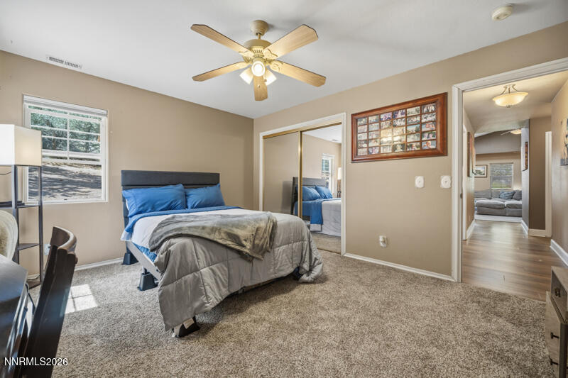 1931 Lousetown Road Reno, NV 89521 - Photo 20 of 51 a bedroom with a large bed and a chandelier