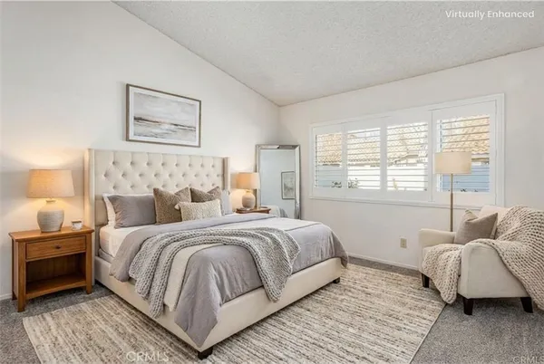 a bedroom with a large bed and a couch