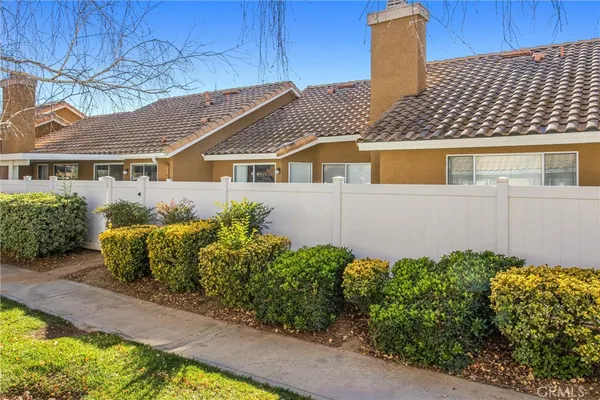 a front view of a house with a yard and mountain view