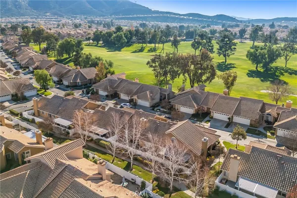 an aerial view of residential houses with outdoor space and river