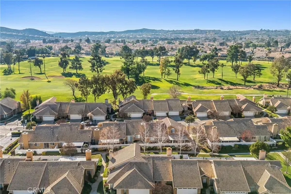 an aerial view of residential houses with outdoor space and parking