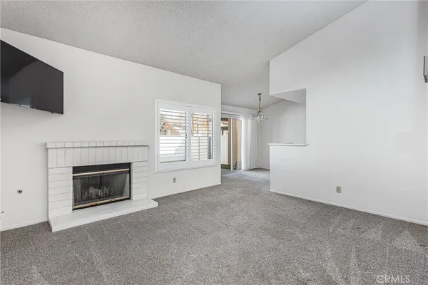 a view of empty room with a fireplace