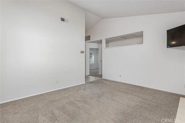 a view of an empty room with a tv