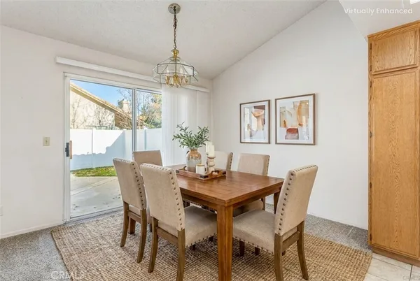 a dining room with furniture a chandelier and wooden floor