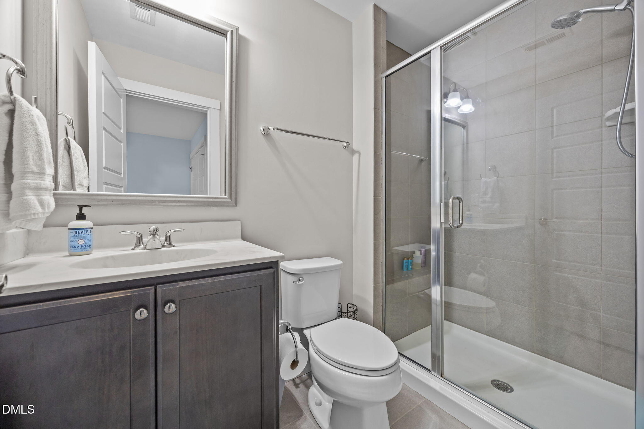 2791 Stone Rock Drive, Unit 113 Raleigh, NC 27604 - Photo 15 of 25 a bathroom with a granite countertop sink toilet and shower