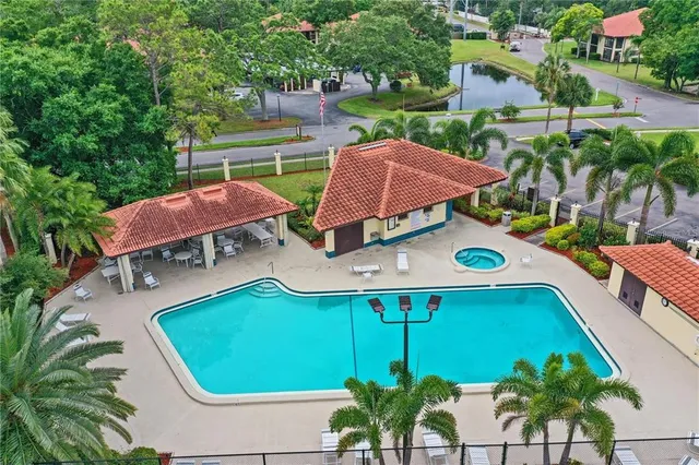 an aerial view of a house with garden space and swimming pool
