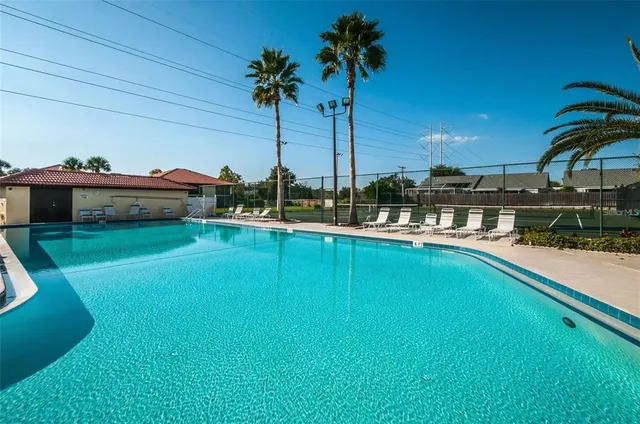 a view of a swimming pool with a table and chairs
