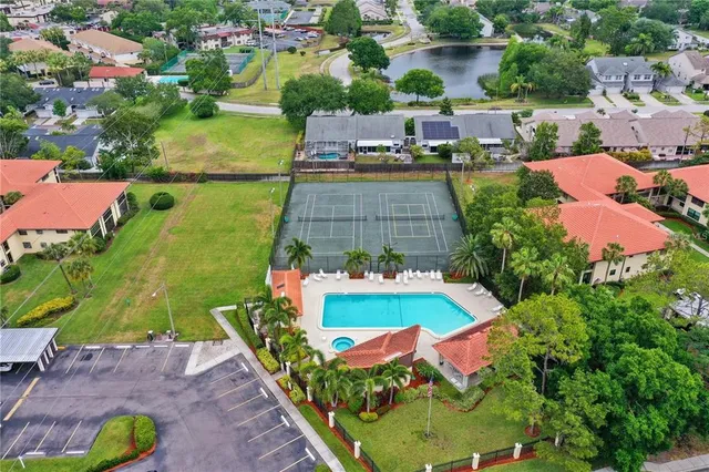 an aerial view of a house with a garden and swimming pool