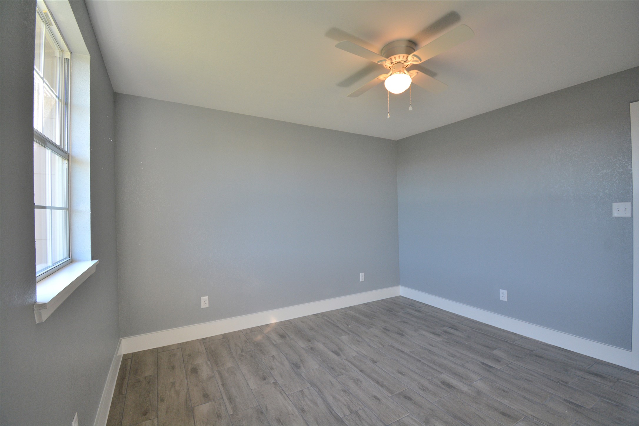 3335 Lafferty Road Pasadena, TX 77504 - Photo 6 of 13 wooden floor in an empty room with a window