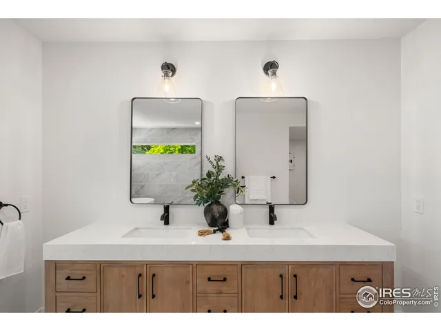 a spacious bathroom with a sink and a mirror