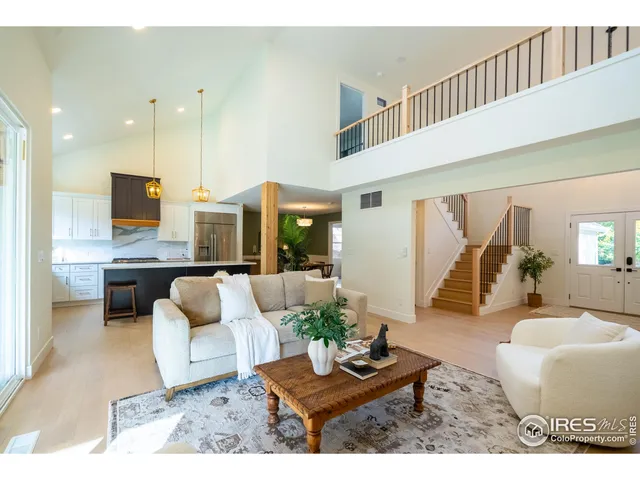 a living room with furniture and view of kitchen
