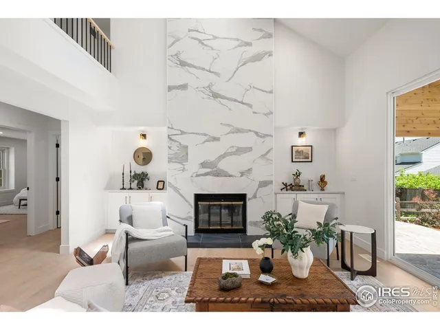 a living room with furniture potted plant and a fireplace