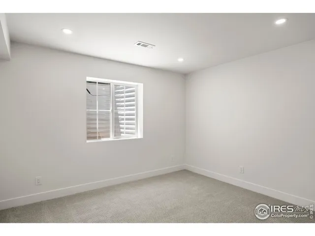 a living room with stainless steel appliances kitchen island granite countertop a sink and a refrigerator
