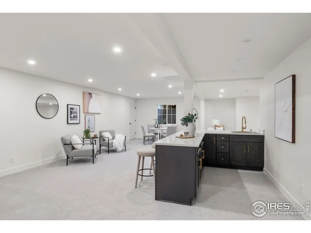 a living room with furniture a chandelier and a dining table