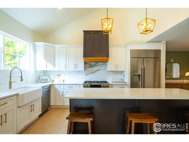 a kitchen with stainless steel appliances granite countertop a sink and cabinets