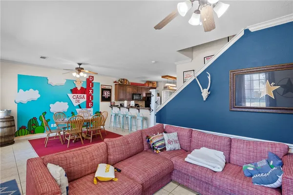 a living room with furniture and wooden floor