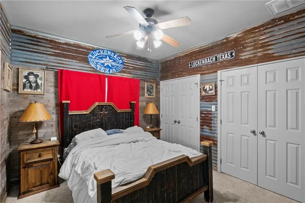 a kitchen with a sink a refrigerator and chairs