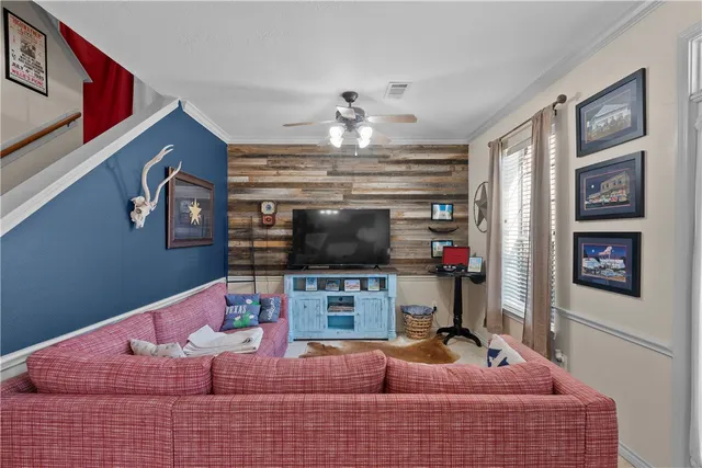 a living room with fireplace furniture and a flat screen tv
