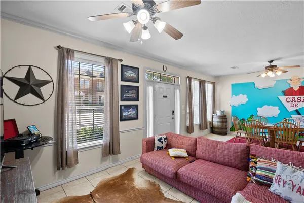 a living room with furniture a flat screen tv and a large window