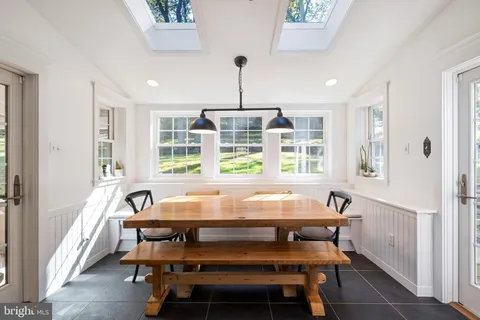 a outdoor sitting area with swimming pool and furniture