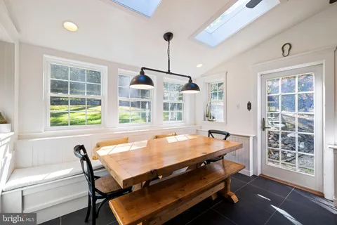 a room with pool table and windows