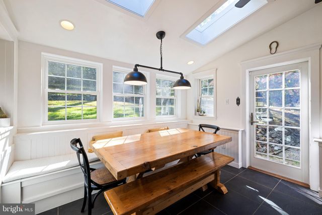 a room with pool table and windows