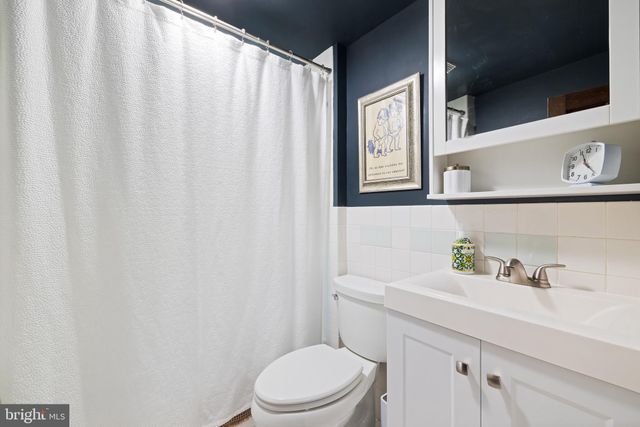 a bathroom with a sink a toilet and a window