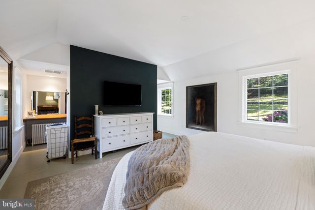 a bedroom with furniture and flat screen tv