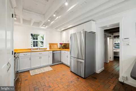 a kitchen with a refrigerator sink and cabinets