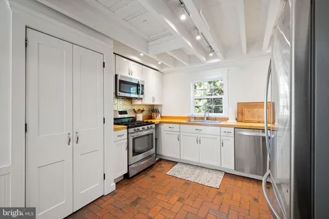 a kitchen with a refrigerator stove and sink