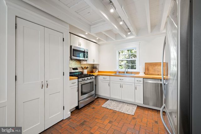 a kitchen with a refrigerator stove and sink