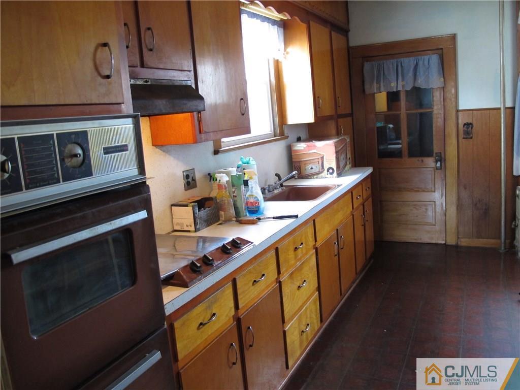350 Summit Avenue Perth Amboy, NJ 08861 - Photo 2 of 20 a kitchen with stainless steel appliances a sink stove and refrigerator