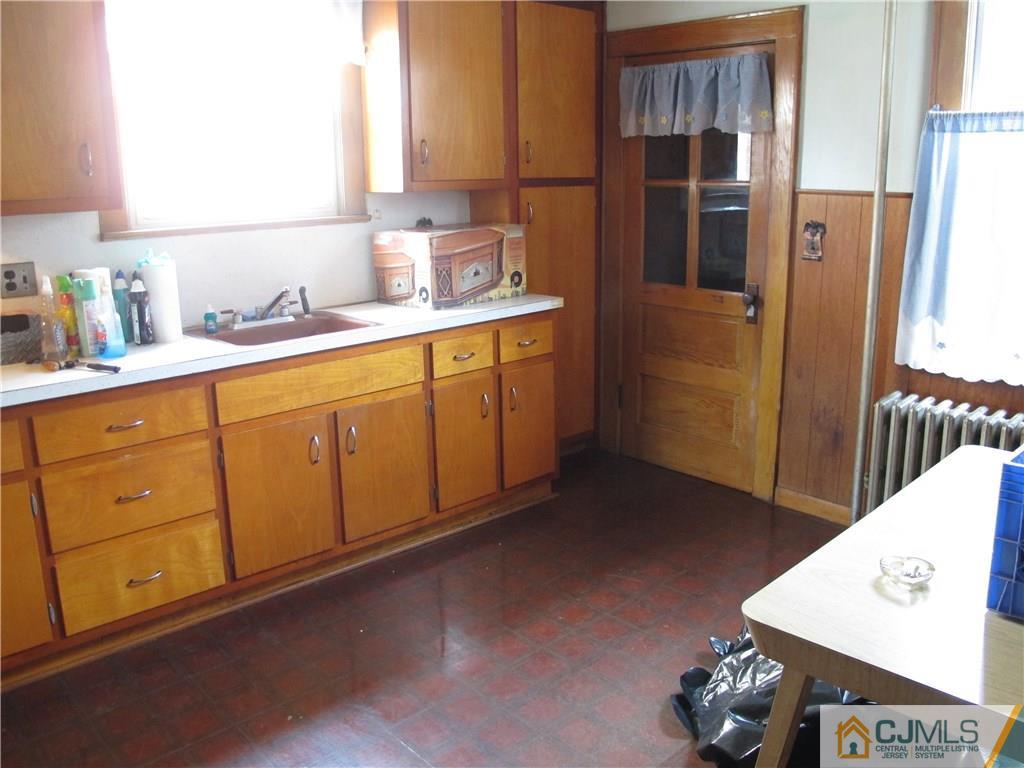 350 Summit Avenue Perth Amboy, NJ 08861 - Photo 6 of 20 a kitchen with stainless steel appliances granite countertop a refrigerator a stove and a sink with wooden cabinets