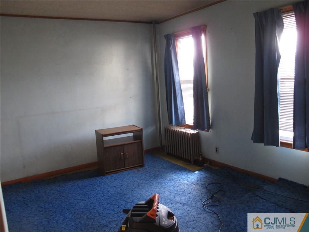 350 Summit Avenue Perth Amboy, NJ 08861 - Photo 7 of 20 an empty room with windows and hardwood floor