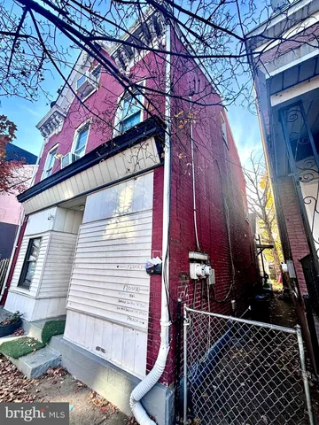 a kitchen with a stove white cabinets and white appliances
