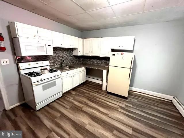 a bathroom with a shower curtain and a sink curtain